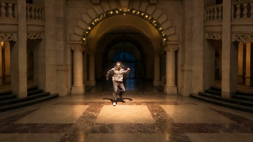 The same location as a finished, generated film scene, with an actor in frame